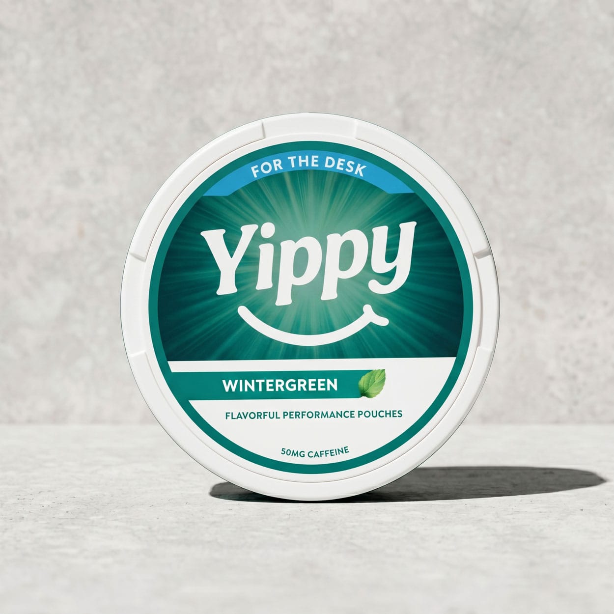 Yippy For The Desk Wintergreen tin on a warm wood desk